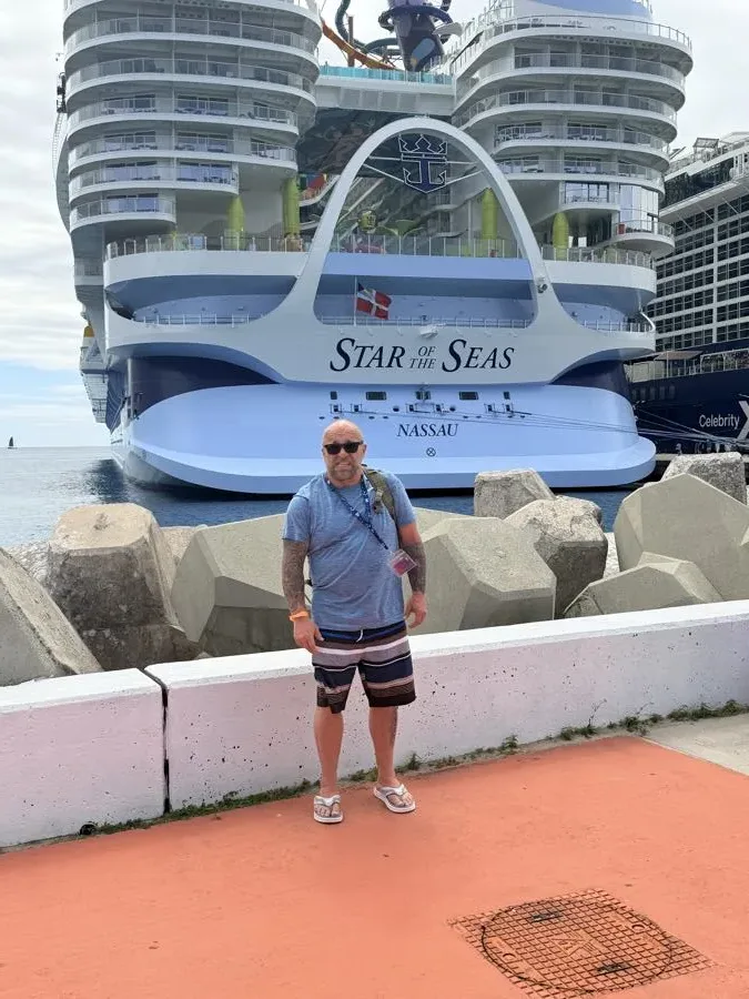 A guest on the deck of a Royal Caribbean ship